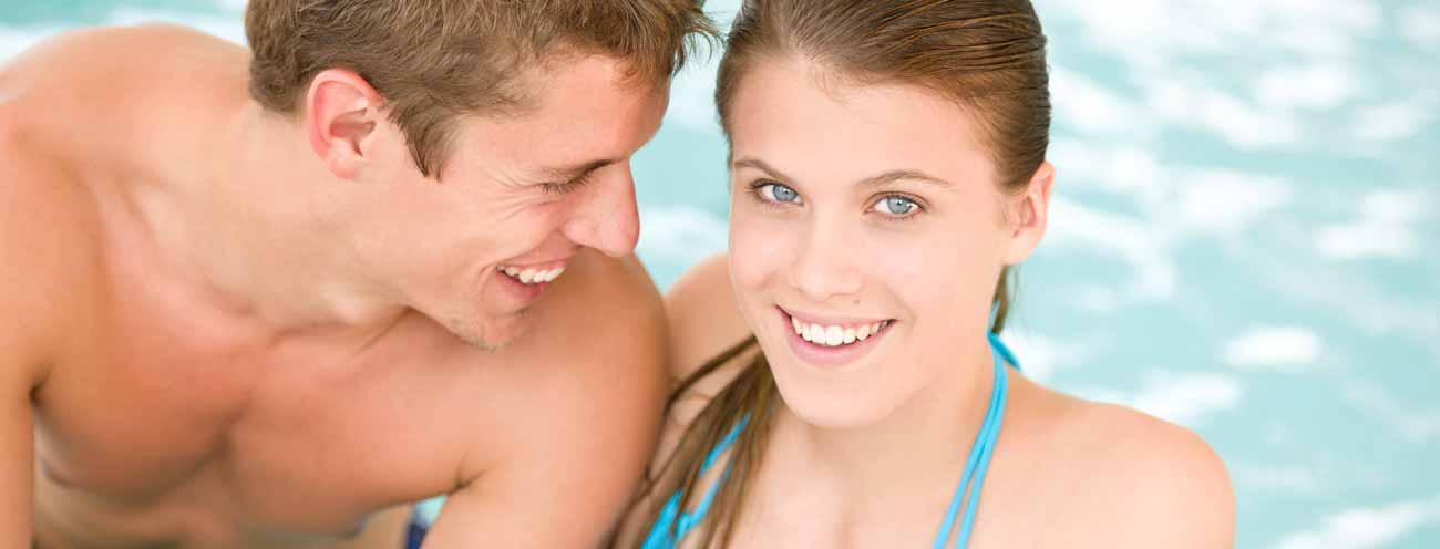 Smiling couple in the swimming pool